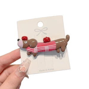 Cute brown dachshund puppy hair clip with red checkered pattern on white background