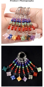 Detail of seven chakra energy stones and Merkaba star pendant on a metal keychain