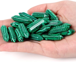 Macro view of double-pointed malachite hexagonal stone pendants with natural green patterns