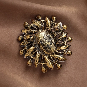Vintage emerald flower brooch in antique gold finish showing back pin buckle detail