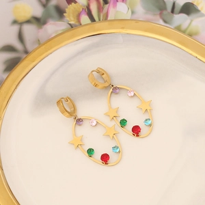 Detail of gold oval earrings featuring colorful inlaid gemstones and star charms
