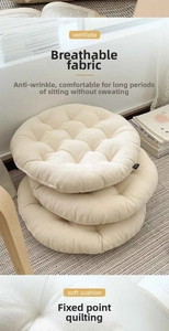 Detail of three stacked beige round cushions with breathable quilted fabric texture