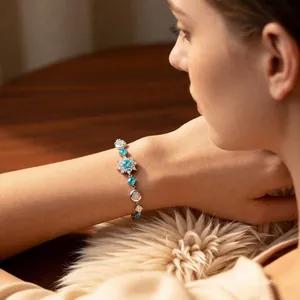 Elegant snowflake bracelet with light blue zircon stones on a soft fur background