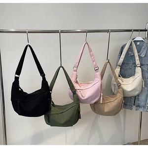 Corduroy dumpling bags in black, green, pink, and beige with adjustable drawstring straps