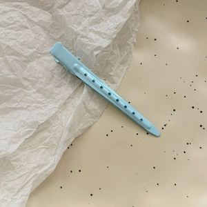 Detail shot of light blue matte alloy seamless hair clip with hollow design pattern