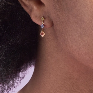 Close-up of S925 silver flower earrings with vertical colorful crystals on model