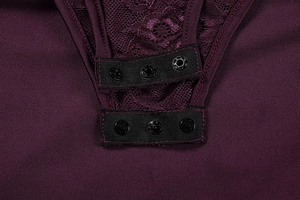 Close-up of lace bodysuit bottom featuring triple snap button closure and stitching