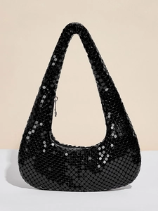 Macro detail of black metallic sequin mesh texture on a hobo evening handbag