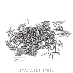 Detailed view of bulk 6x1mm stainless steel dowel pins on white background