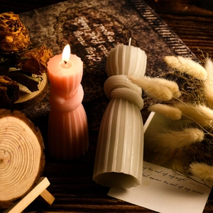 Detail of knot-shaped aromatherapy candles with ribbed texture in a vintage setting