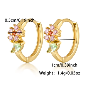 Detail view of gold floral hoop earrings with pink zircons and green leaf accents
