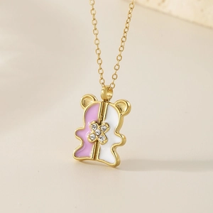 Detail of bear-shaped pendant with pink and white enamel and diamond-set clover
