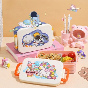Close-up of multi-layer bento lunch boxes with secure side latches and cute patterns