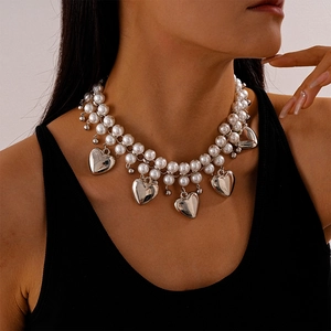 Exaggerated double-layered pearl necklace with silver heart charms for a vintage look