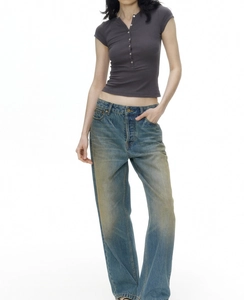 Slim fit dark gray henley shirt paired with vintage blue straight jeans on model