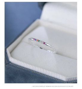Macro shot of colorful zircon gems set in a S925 sterling silver ring on velvet box