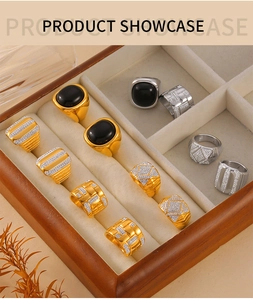 Macro detail of retro gold and silver rings with black agate and pavé diamonds in a box