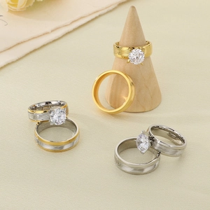 Detailed view of stainless steel wedding bands with round zircon and brushed texture