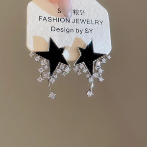 Macro view of S925 silver needle star earrings with tassel cubic zirconia details