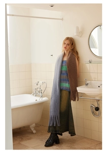 Detailed view of extra long wool blend scarf with grey-blue and brown gradient and fringe