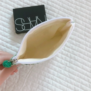 Close-up of floral cotton mini pouch showing internal lining and green zipper detail