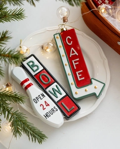 Retro Christmas cafe and bowl signs ornaments displayed with festive pine and warm lights