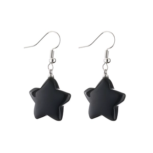 Close-up of black star pendant earrings with silver hooks on a clean white background
