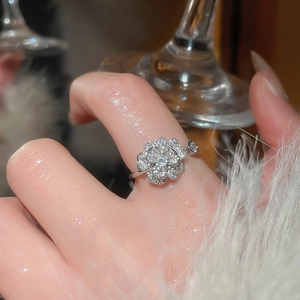 Macro shot of silver camellia open ring with pavé zircons and crystal leaf accents