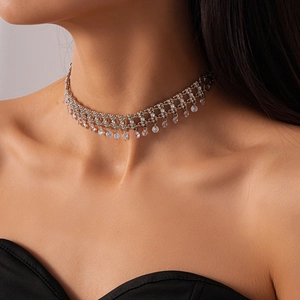 Detail of silver choker necklace featuring mesh structure and dangling zircon tassels