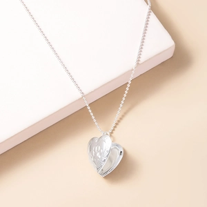 Silver heart locket necklace with footprint engraving on ball chain shown open