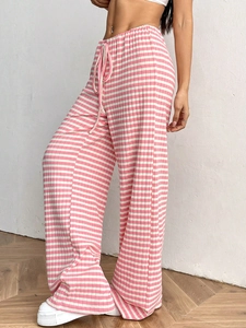Detail of pink and white striped knit trousers showing vertical texture and drawstring