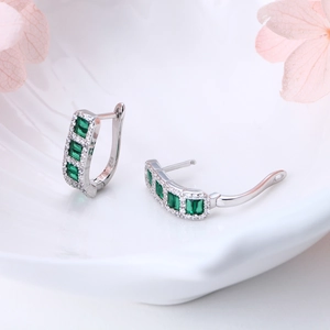 Macro shot of S925 sterling silver hoop earrings with emerald green zircon stones