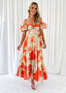 Detail of orange floral maxi dress with off-shoulder puff sleeves and tiered skirt texture