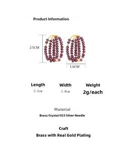 Macro view of C-shaped earrings with purple crystal beads and gold plating details