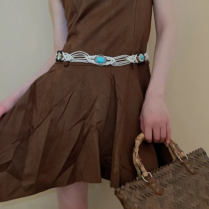 Detail of Bohemian hand-woven waist chain with turquoise stone and wooden beads