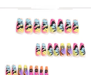 Detail of long press-on nails featuring graffiti skulls, hearts, and rhinestone accents