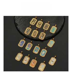 Detail of tarot style enamel pendants with sun, moon and evil eye motifs in gold finish