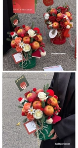 Detail view of a Christmas apple gift box with red roses and festive winter decorations