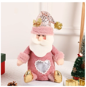 Detailed view of pink Santa plush with heart window and sequin hat on festive display