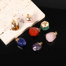 Macro shot of assorted faceted natural gemstone pendants with gold plating on stone