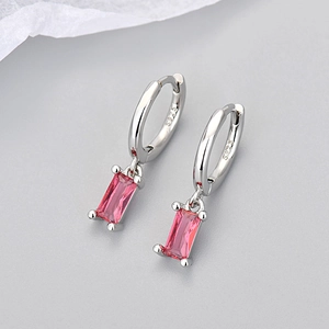Close-up of S925 silver hoop earrings with rectangular pink zircon gemstone drops