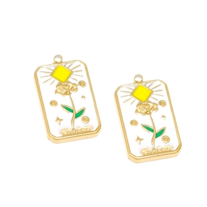 Golden rectangular floral enamel pendant with white rose design and Lovers text