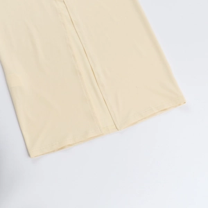 Detail shot of fine stitching and cream fabric texture on an elegant evening dress