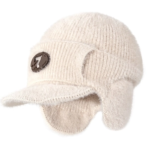 Plush cream knit winter trapper hat with visor and ear flaps for cold weather warmth