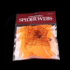 Packaged orange stretchable spider webs with small plastic spiders for Halloween decor