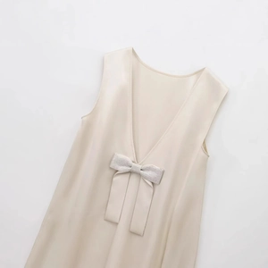 Elegant champagne satin sleeveless dress with deep V-neck and rhinestone bow decoration