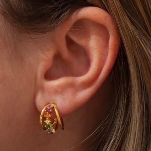 Close-up of double-loop rainbow cubic zirconia hoop earrings on a female model