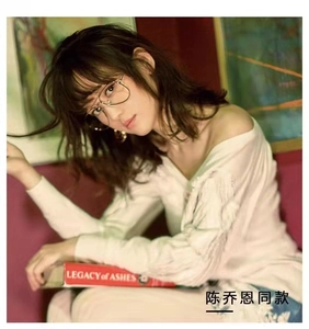 Detail shot of aviator metal glasses frame worn by a model in a casual indoor setting