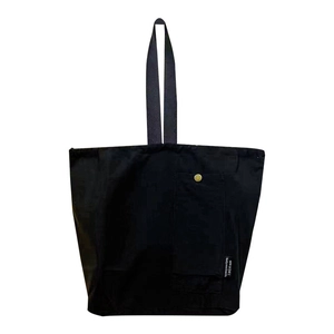 Large black waterproof lunch bag with long handles and golden metal snap button