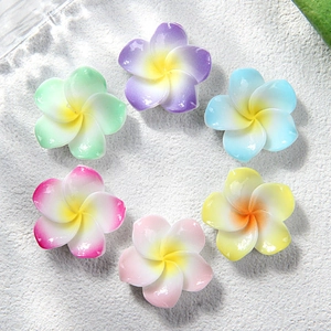 Colorful resin plumeria flowers in gradient shades for DIY hair clips and crafts